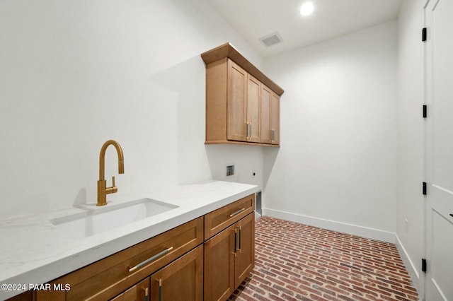 washroom with hookup for an electric dryer, cabinets, sink, and washer hookup