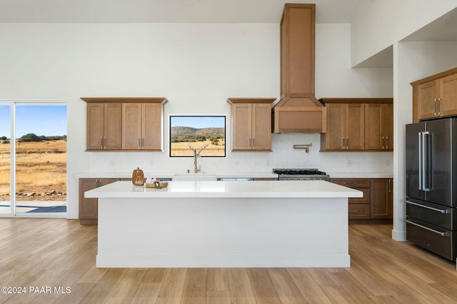 kitchen featuring stainless steel appliances, a healthy amount of sunlight, and light hardwood / wood-style floors