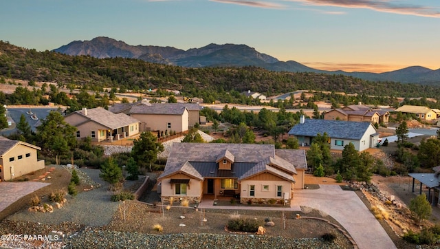 aerial view at dusk featuring a residential view and a mountain view