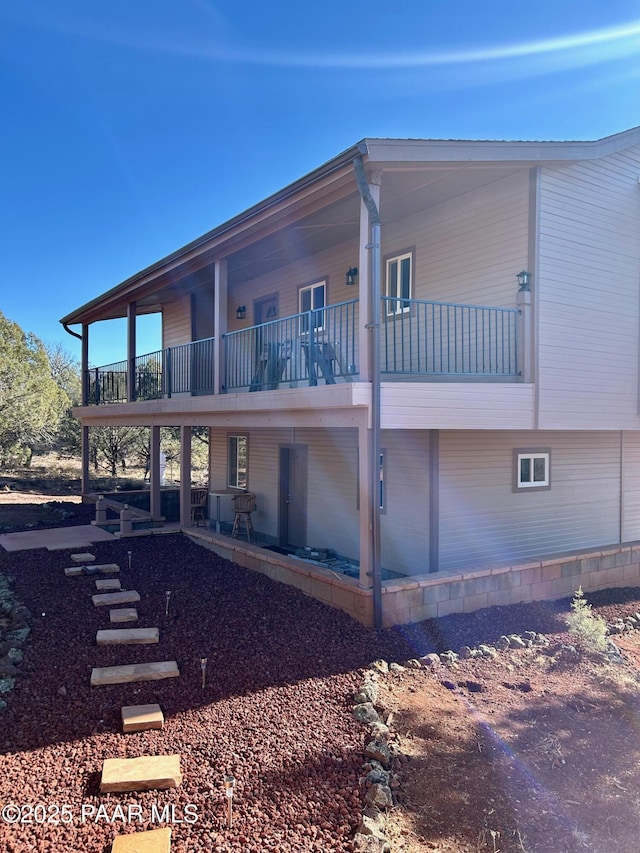 back of property featuring a balcony