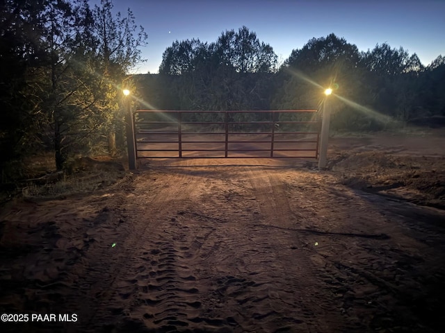 gate at dusk featuring a rural view