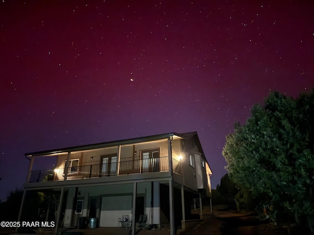 back house at night with a balcony