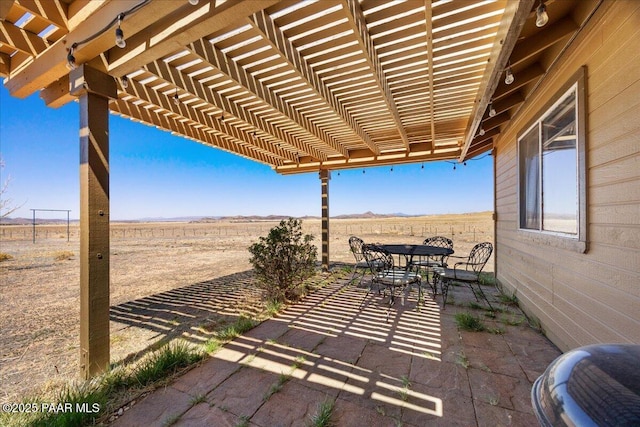 1250 Pronghorn Trl, Chino Valley, AZ 86323 - view of patio featuring a rural view, a pergola, and outdoor dining area