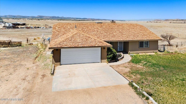 1250 Pronghorn Trl, Chino Valley, AZ 86323 - ranch-style home featuring a chimney, fence, a shingled roof, a mountain view, and concrete driveway