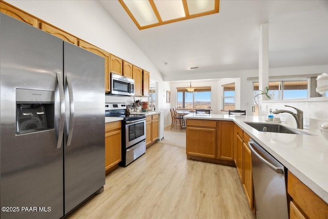 1250 Pronghorn Trl, Chino Valley, AZ 86323 - kitchen featuring light wood finished floors, a sink, light countertops, appliances with stainless steel finishes, and lofted ceiling