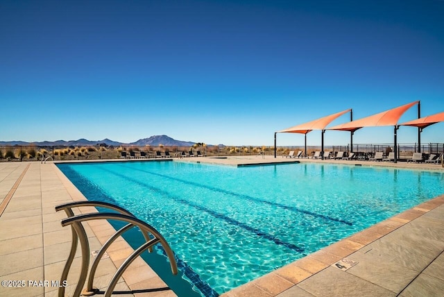 community pool with fence and a mountain view