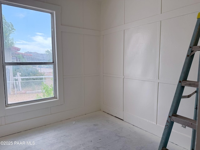 12972 E Main St, Dewey-Humboldt, AZ 86329 - unfurnished room featuring a decorative wall and light wood-style floors