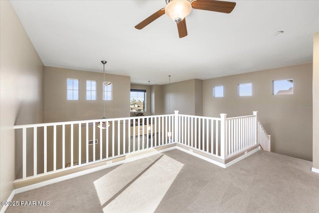 unfurnished room featuring ceiling fan and carpet floors