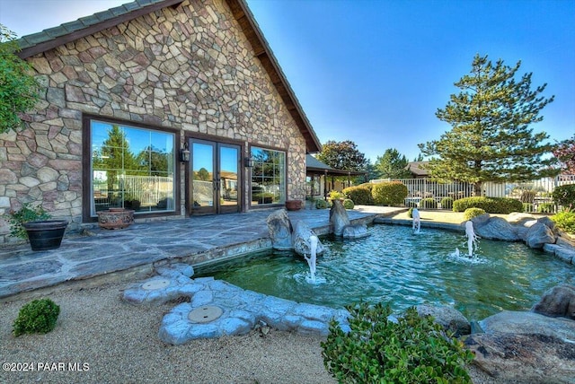 view of swimming pool with pool water feature