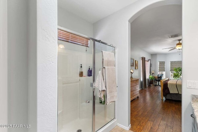 7605 E Circle Wagons Way, Prescott Valley, AZ 86315 - full bathroom with a stall shower, ceiling fan, connected bathroom, and hardwood / wood-style floors