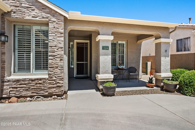 7334 E Goodnight Ln, Prescott Valley, AZ 86314 - entrance to property featuring a porch, stone siding, and stucco siding