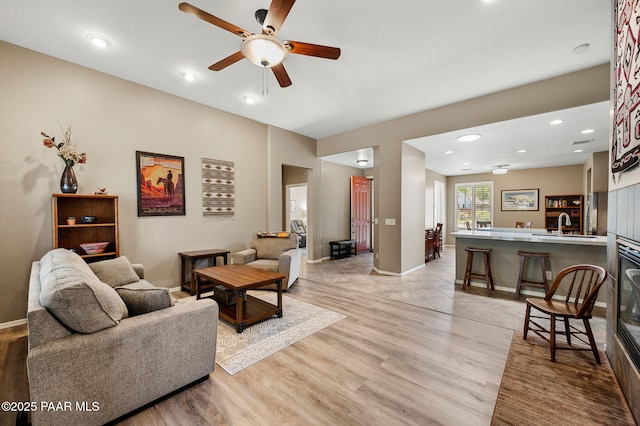 7334 E Goodnight Ln, Prescott Valley, AZ 86314 - living area with light wood-type flooring, ceiling fan, baseboards, and recessed lighting