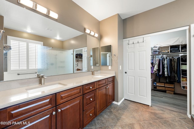 7334 E Goodnight Ln, Prescott Valley, AZ 86314 - bathroom with a spacious closet, double vanity, a shower, and baseboards