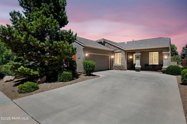 7334 E Goodnight Ln, Prescott Valley, AZ 86314 - ranch-style house featuring an attached garage, driveway, stucco siding, and stone siding