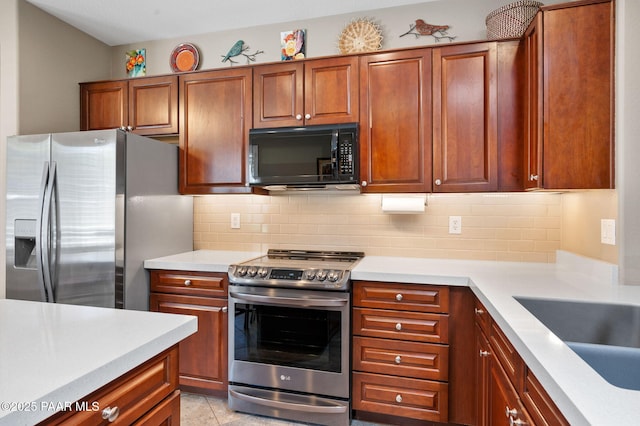 7334 E Goodnight Ln, Prescott Valley, AZ 86314 - kitchen with stainless steel appliances, light countertops, and tasteful backsplash