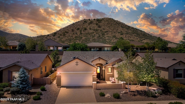 view of front of home with a mountain view and a garage