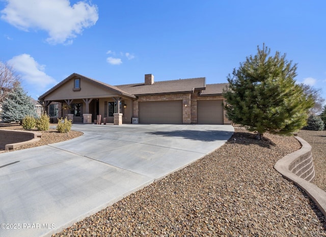 view of front of house featuring a garage, concrete driveway, and a chimney