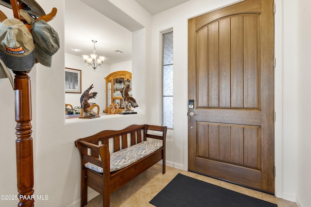 foyer featuring baseboards, visible vents, an inviting chandelier, and light tile patterned floors