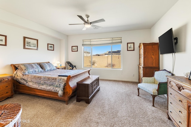 bedroom with a ceiling fan, carpet floors, and baseboards