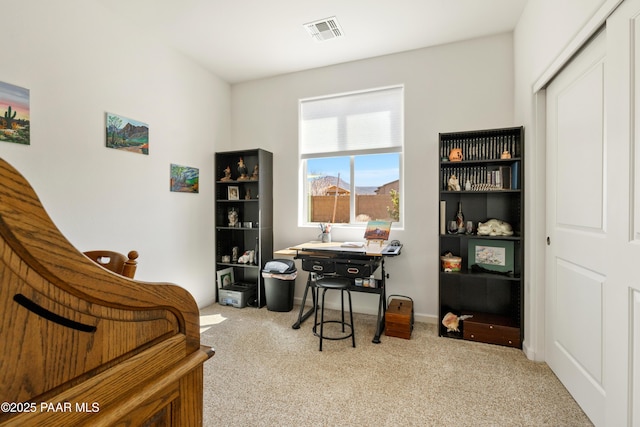 office area with baseboards, visible vents, and carpet