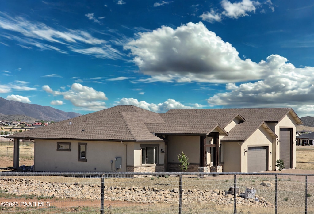 9827 N Constellation Ct, Prescott Valley, AZ 86315 - view of front of property featuring stucco siding, a garage, and a fenced front yard