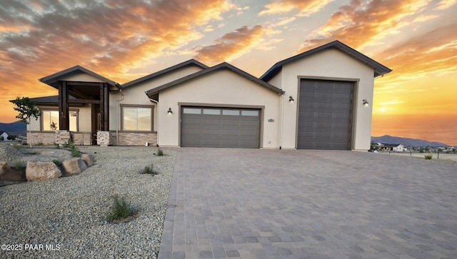 9827 N Constellation Ct, Prescott Valley, AZ 86315 - ranch-style house featuring stucco siding, a garage, decorative driveway, and stone siding