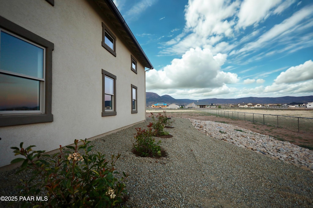 9827 N Constellation Ct, Prescott Valley, AZ 86315 - view of side of property with a mountain view and stucco siding