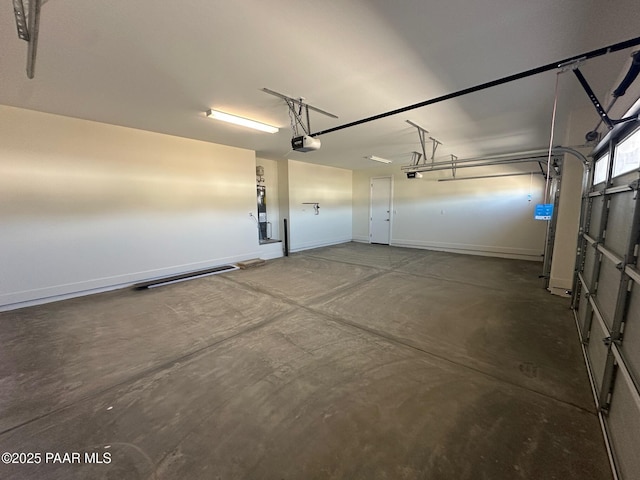 garage with baseboards and a garage door opener