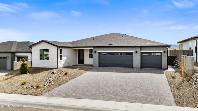 7519 E Louie Ln, Prescott Valley, AZ 86315 - view of front of house featuring decorative driveway, fence, an attached garage, and a shingled roof
