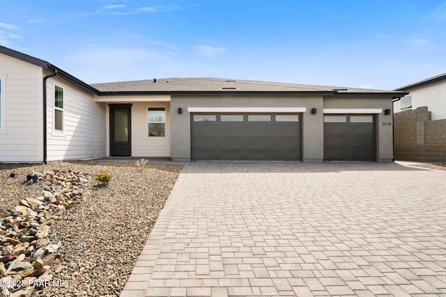 7519 E Louie Ln, Prescott Valley, AZ 86315 - view of front of house with stucco siding, decorative driveway, a garage, and roof with shingles