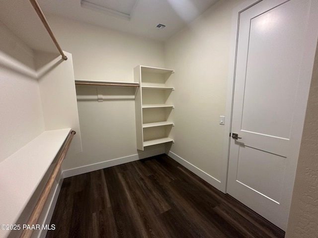 walk in closet featuring dark wood-style flooring and visible vents