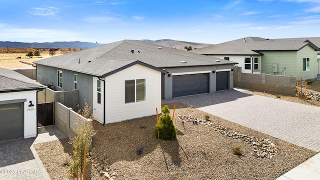 7519 E Louie Ln, Prescott Valley, AZ 86315 - view of front of home featuring a mountain view, decorative driveway, a garage, and fence