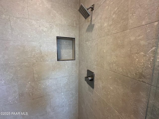 interior details with a tile shower