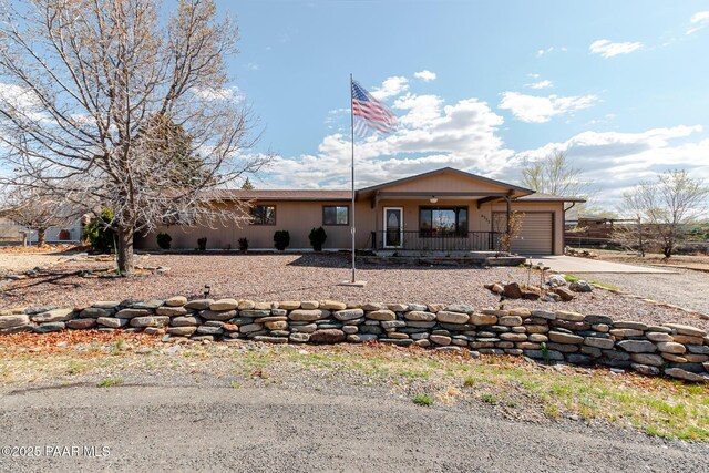 6333 E Lord Cir, Prescott Valley, AZ 86314 - ranch-style home with a garage, concrete driveway, and a porch