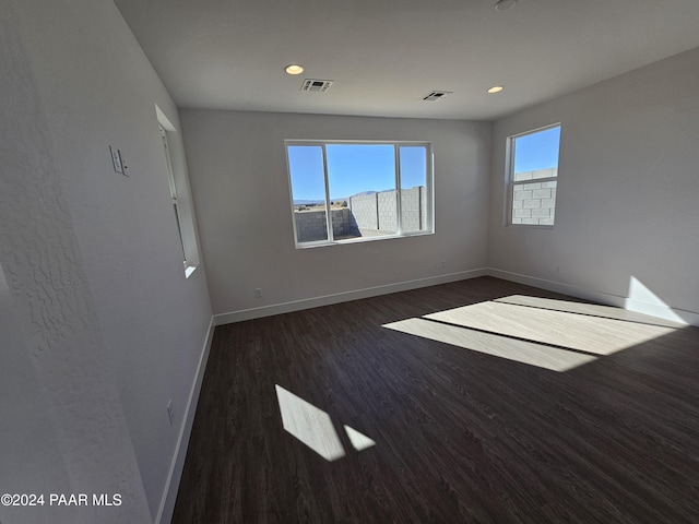 unfurnished room featuring dark hardwood / wood-style flooring