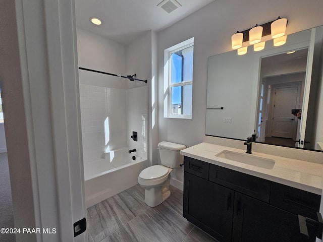 full bathroom featuring vanity, toilet, and tiled shower / bath