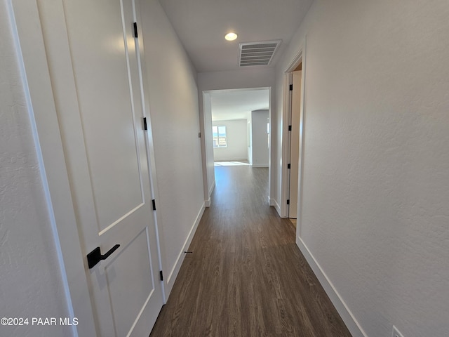 corridor with dark wood-type flooring