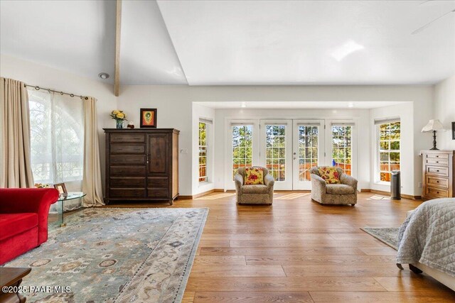 1167 Eagles Nest, Prescott, AZ 86303 - bedroom featuring access to outside, wood finished floors, vaulted ceiling, and french doors