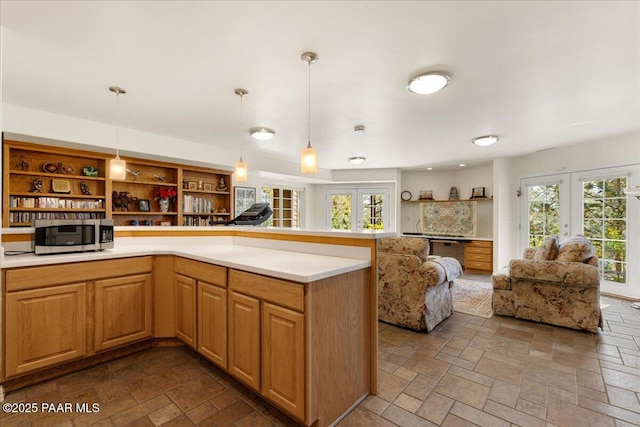 1167 Eagles Nest, Prescott, AZ 86303 - kitchen featuring stainless steel microwave, open floor plan, french doors, and stone tile floors