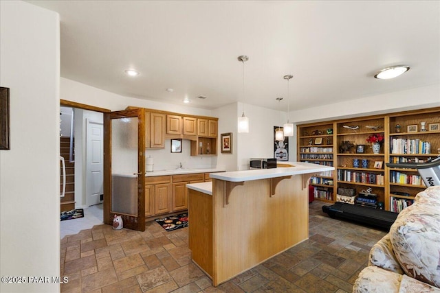 1167 Eagles Nest, Prescott, AZ 86303 - kitchen with a kitchen bar, stone tile floors, light countertops, and recessed lighting