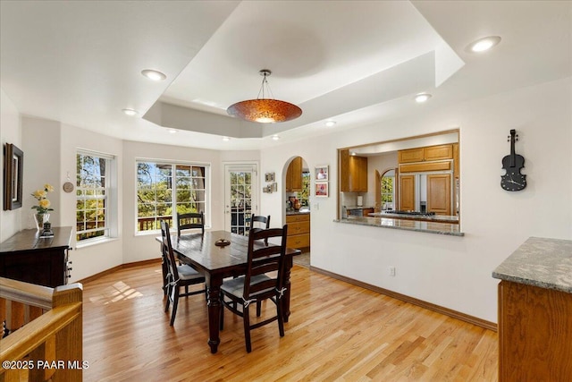 1167 Eagles Nest, Prescott, AZ 86303 - dining space with arched walkways, light wood-style flooring, recessed lighting, and a tray ceiling