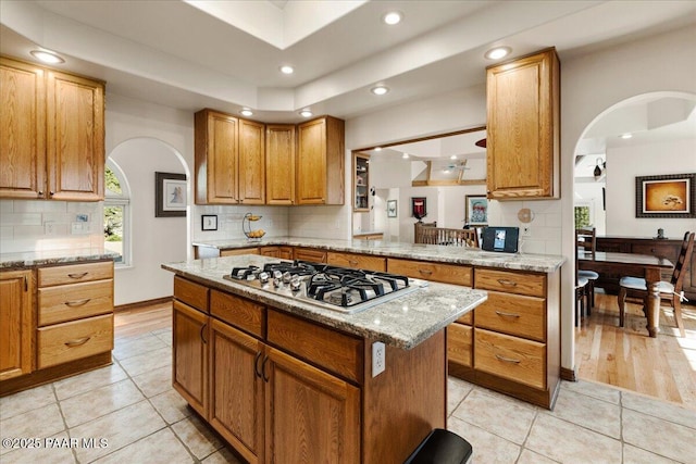 1167 Eagles Nest, Prescott, AZ 86303 - kitchen featuring stainless steel gas cooktop, arched walkways, backsplash, recessed lighting, and light tile patterned floors