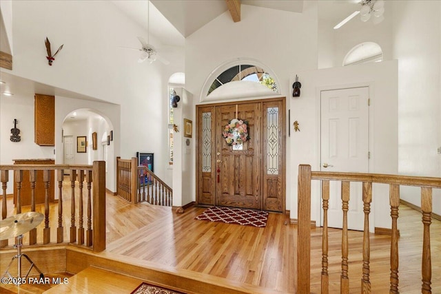 1167 Eagles Nest, Prescott, AZ 86303 - entryway with ceiling fan, wood finished floors, arched walkways, high vaulted ceiling, and beamed ceiling