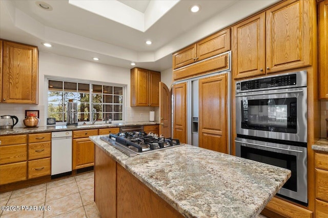 1167 Eagles Nest, Prescott, AZ 86303 - kitchen featuring stainless steel appliances, backsplash, recessed lighting, a kitchen island, and light stone countertops
