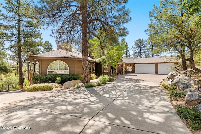 1167 Eagles Nest, Prescott, AZ 86303 - ranch-style home featuring driveway, an attached garage, and a chimney