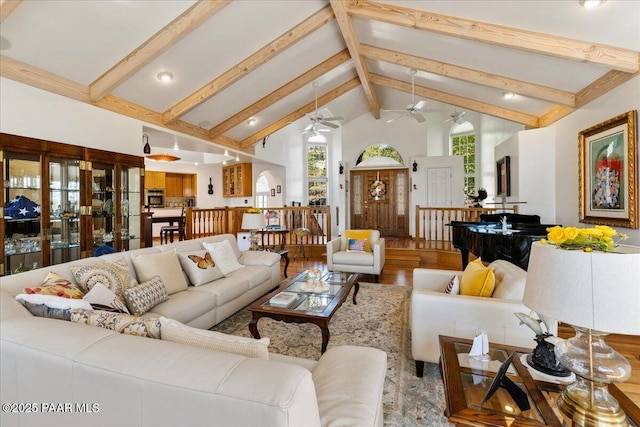 1167 Eagles Nest, Prescott, AZ 86303 - living area featuring a ceiling fan, beamed ceiling, arched walkways, wood finished floors, and high vaulted ceiling
