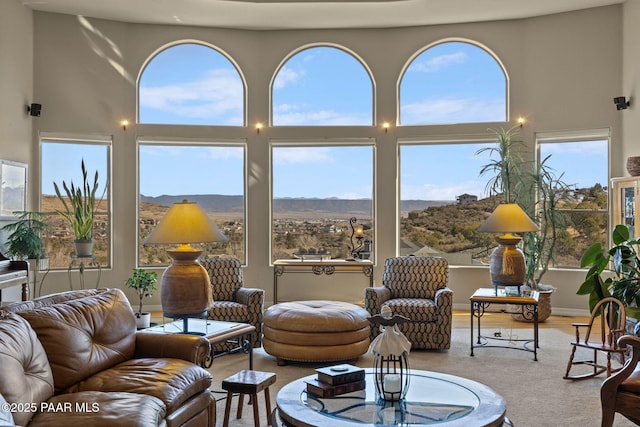 sunroom featuring a healthy amount of sunlight and a mountain view