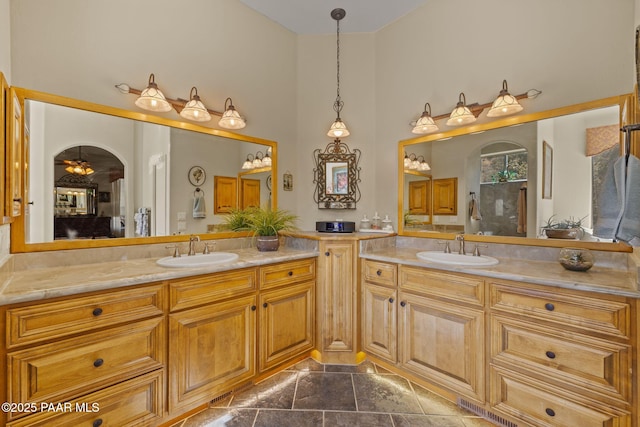 bathroom with a towering ceiling and vanity