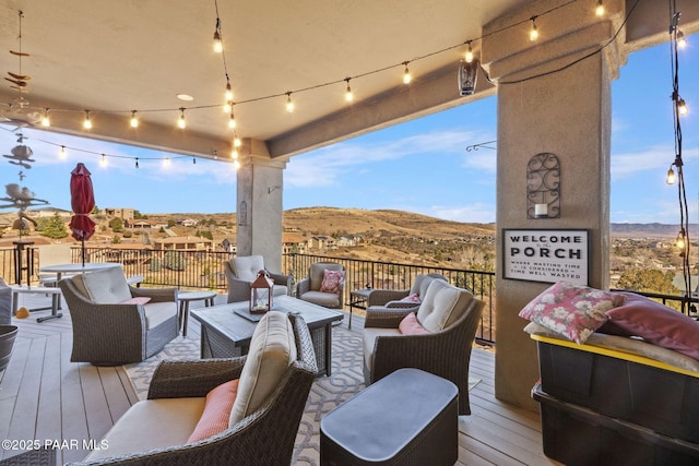 deck with a mountain view and an outdoor living space