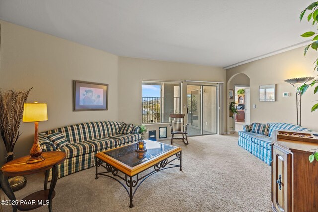 living room featuring light carpet and arched walkways